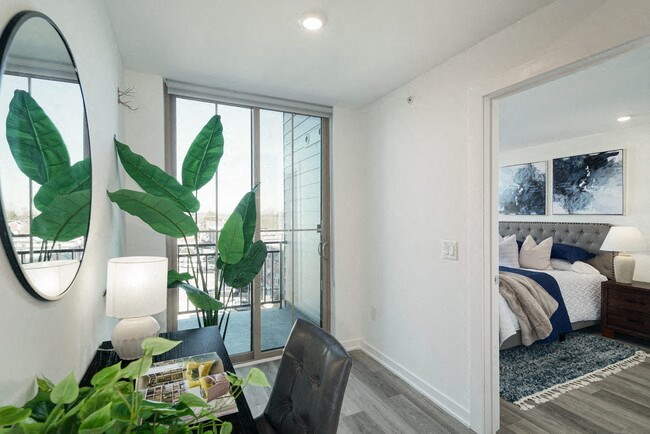 a living room with a bed and a sliding glass door