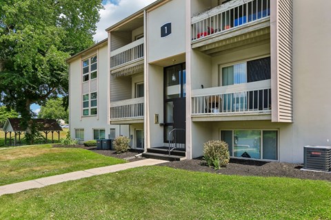 Apartment building with a green lawn in front.