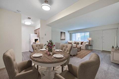 A dining room with a round table set for six.