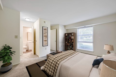 A bedroom with a bed, a potted plant, and a bookshelf.