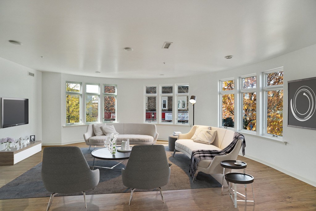 a living room with couches and chairs and a television