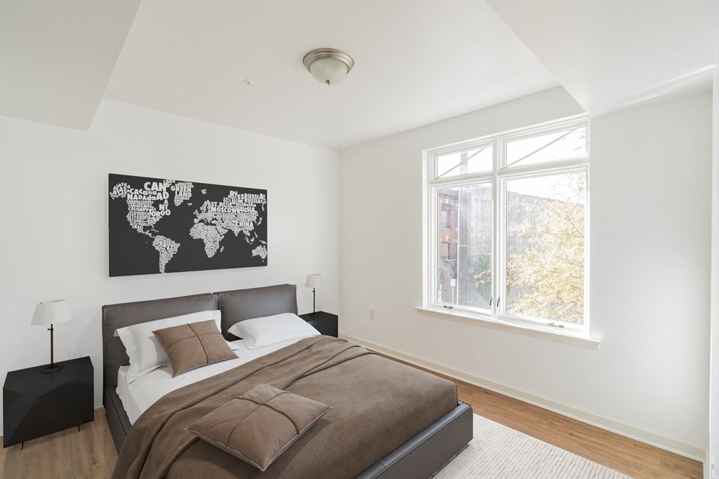 a bedroom with a bed and a world map on the wall