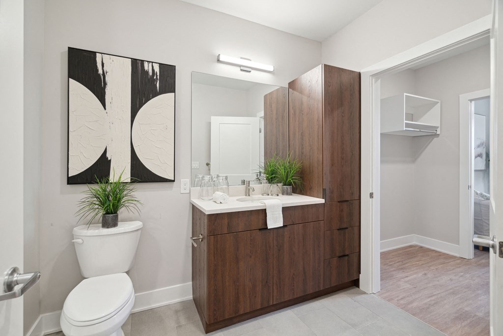 a bathroom with a toilet sink and a mirror