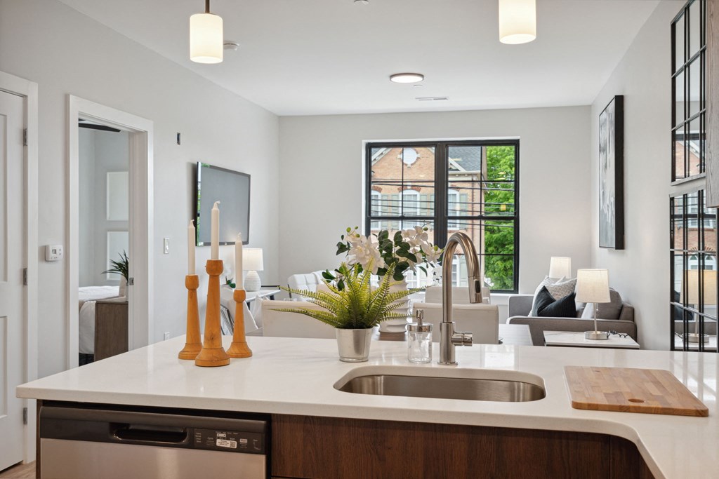 a kitchen with a sink and a view of a living room