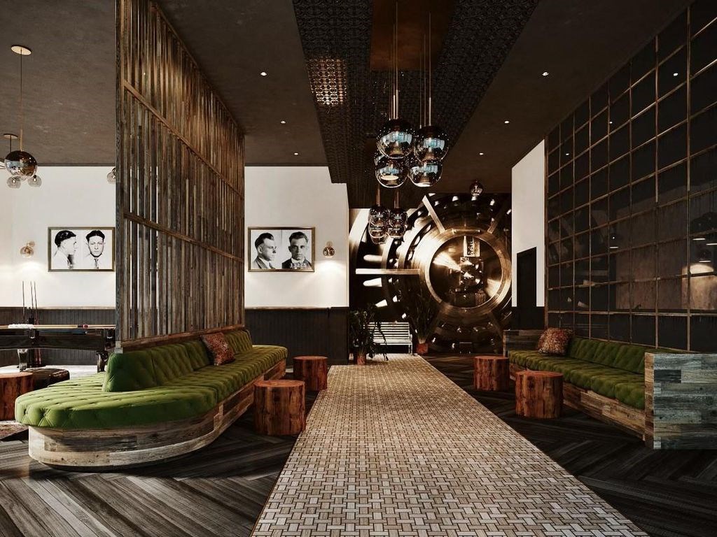 a lobby with green couches and chairs and a large clock