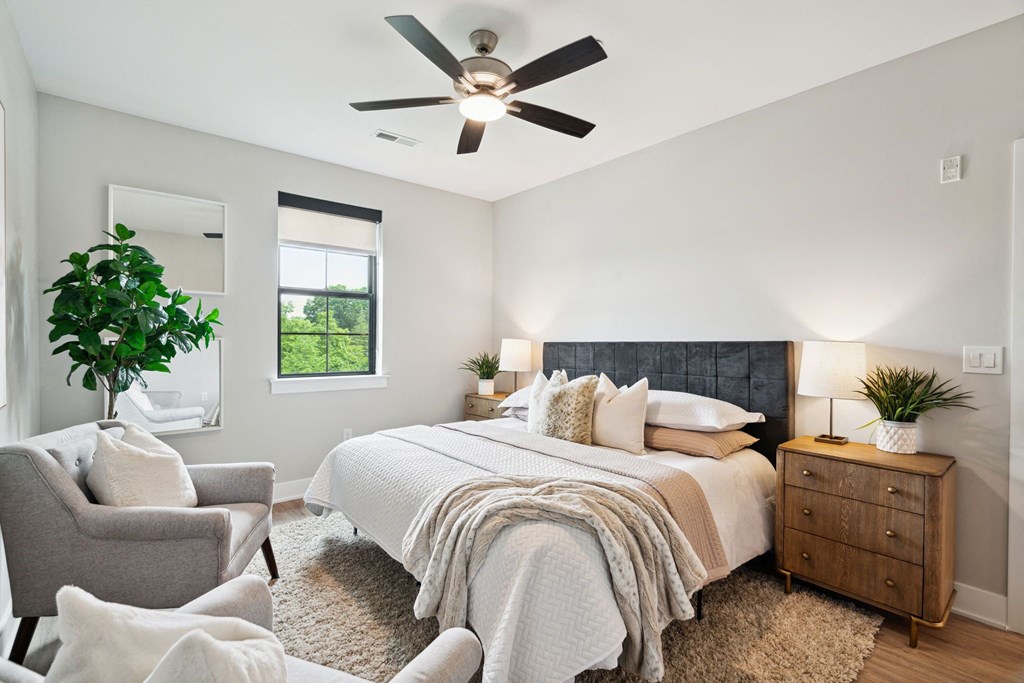 a bedroom with a bed and a ceiling fan