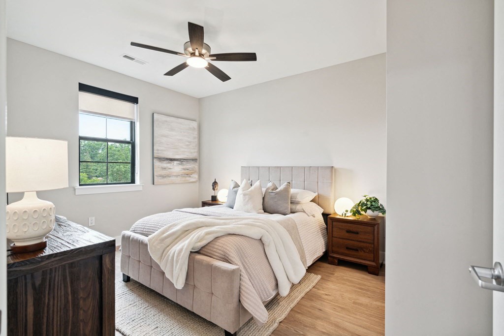 a bedroom with a bed and a ceiling fan