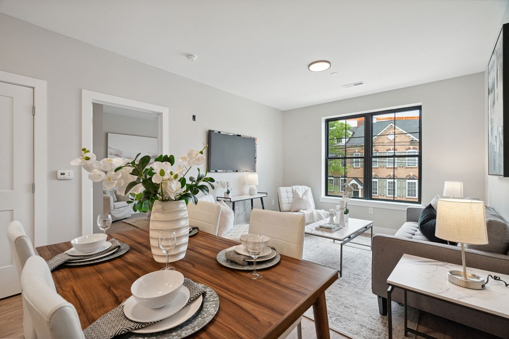 a living room with a wooden dining room table