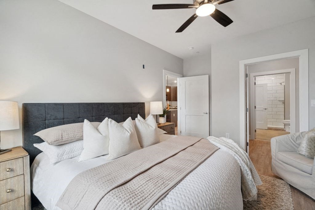 a bedroom with a large bed and a ceiling fan