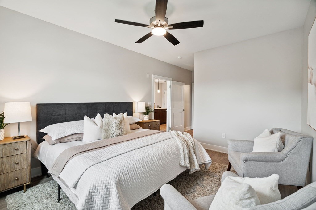 a bedroom with a large bed and a ceiling fan