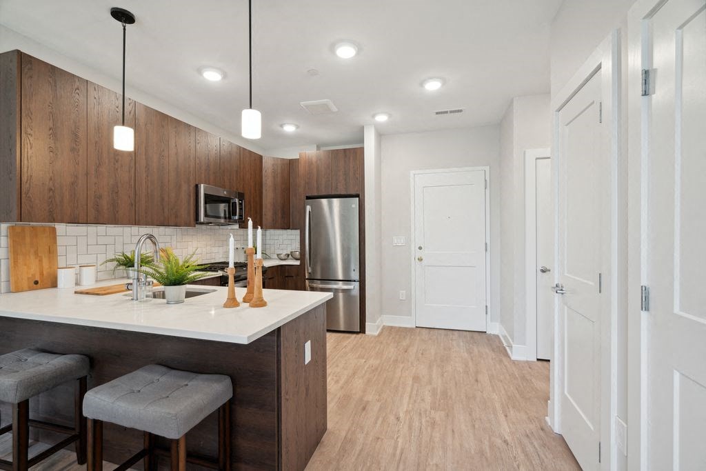 a kitchen with a counter top and a refrigerator