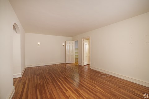 A room with wooden floors and white walls.