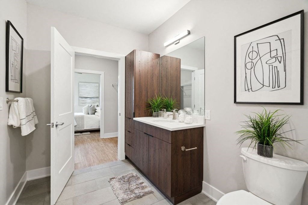 a bathroom with a toilet sink and a mirror