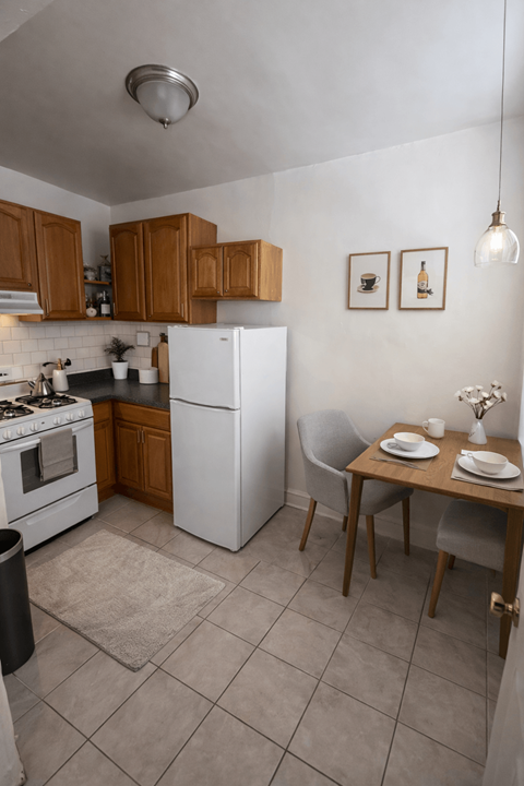 A kitchen with a table and chairs set for two.