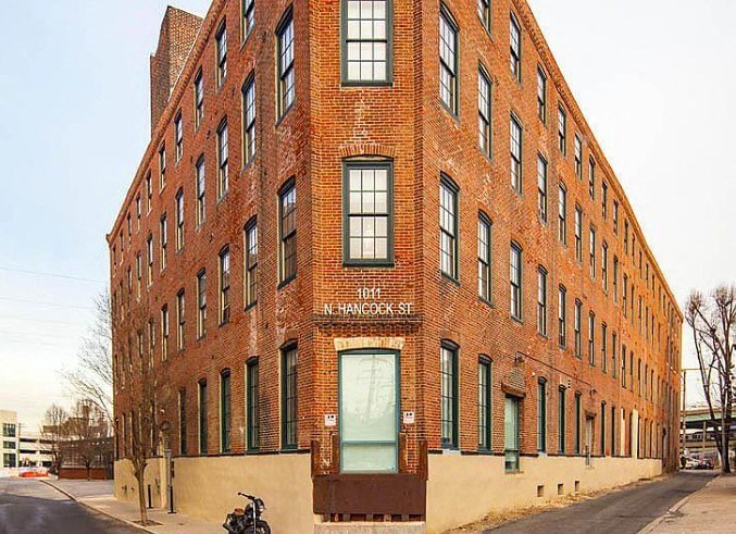 a large brick building with a motorcycle parked in front of it