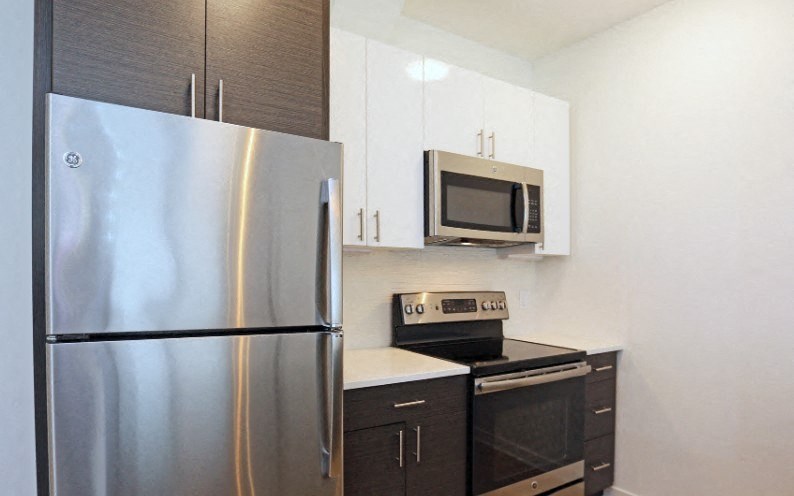 a kitchen with stainless steel appliances and a refrigerator