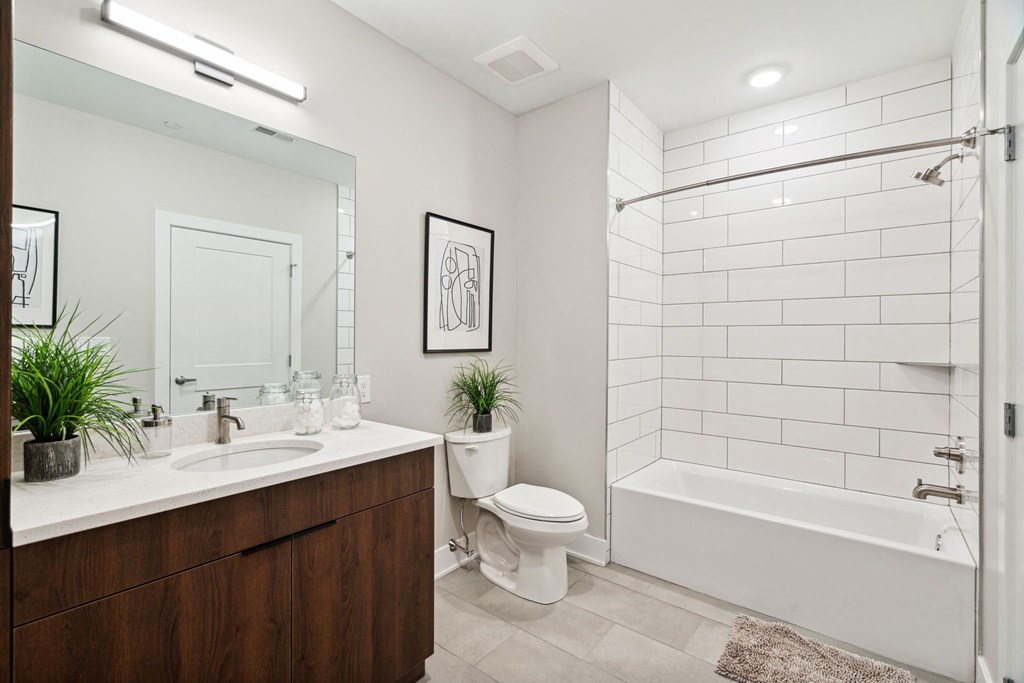 a bathroom with a shower toilet and sink and a mirror