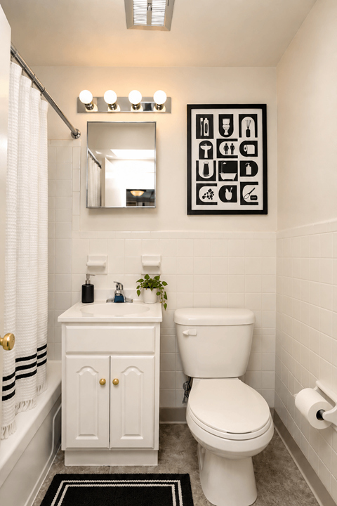 A white toilet sits next to a sink in a bathroom.