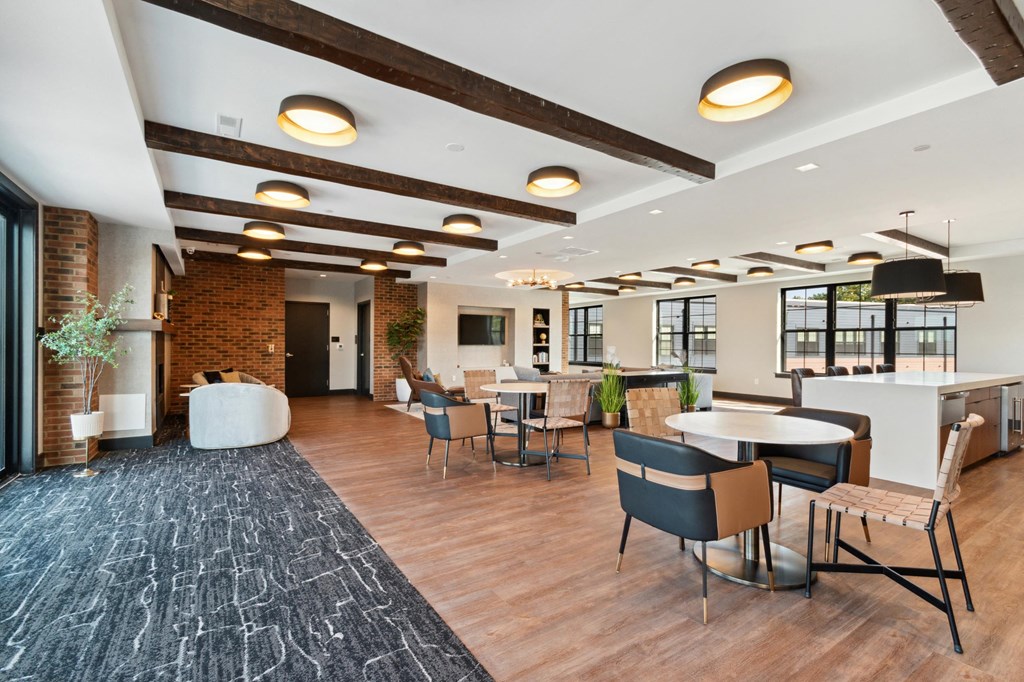 a large lobby with tables and chairs and a bar