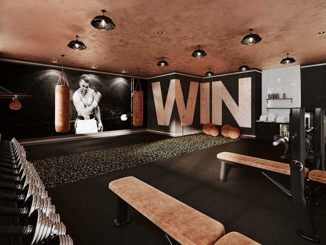 a gym with a bunch of benches and a wall with a win sign