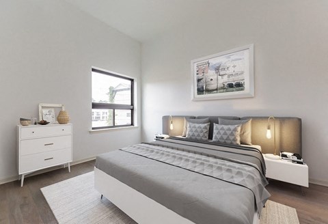 a bedroom with a bed and a window