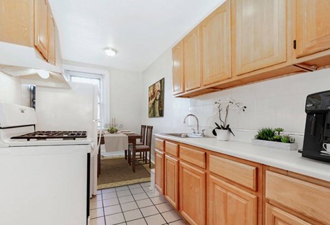 A kitchen with wooden cabinets and a white oven.