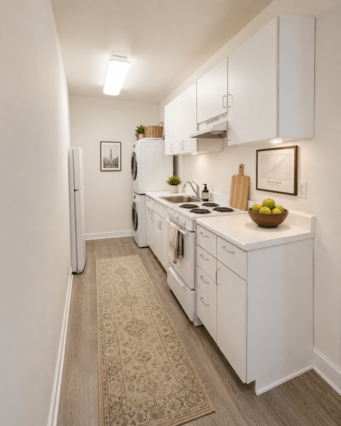A kitchen with white cabinets and a rug on the floor.