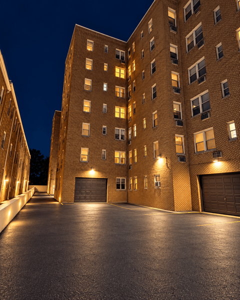 A large brick building with a driveway in front.