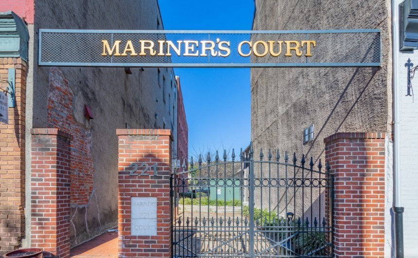 the entrance to mariners court with a wrought iron gate