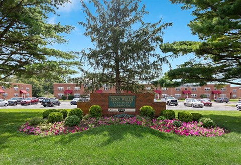 A sign that says "Penn Wells" is in front of a building.