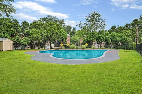 A round swimming pool surrounded by a grassy area.