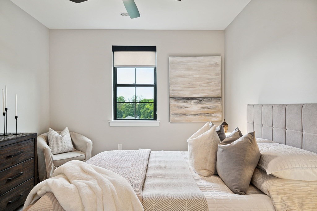 a bedroom with a large bed and a window