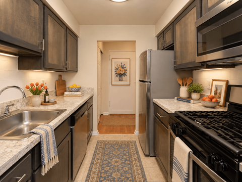 A kitchen with a black stove top oven and a black refrigerator.