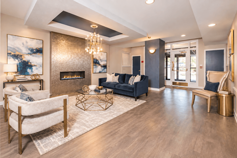 A modern living room with a fireplace and a large painting on the wall.
