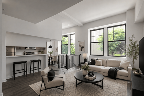 A modern living room with a black coffee table and a white sofa.