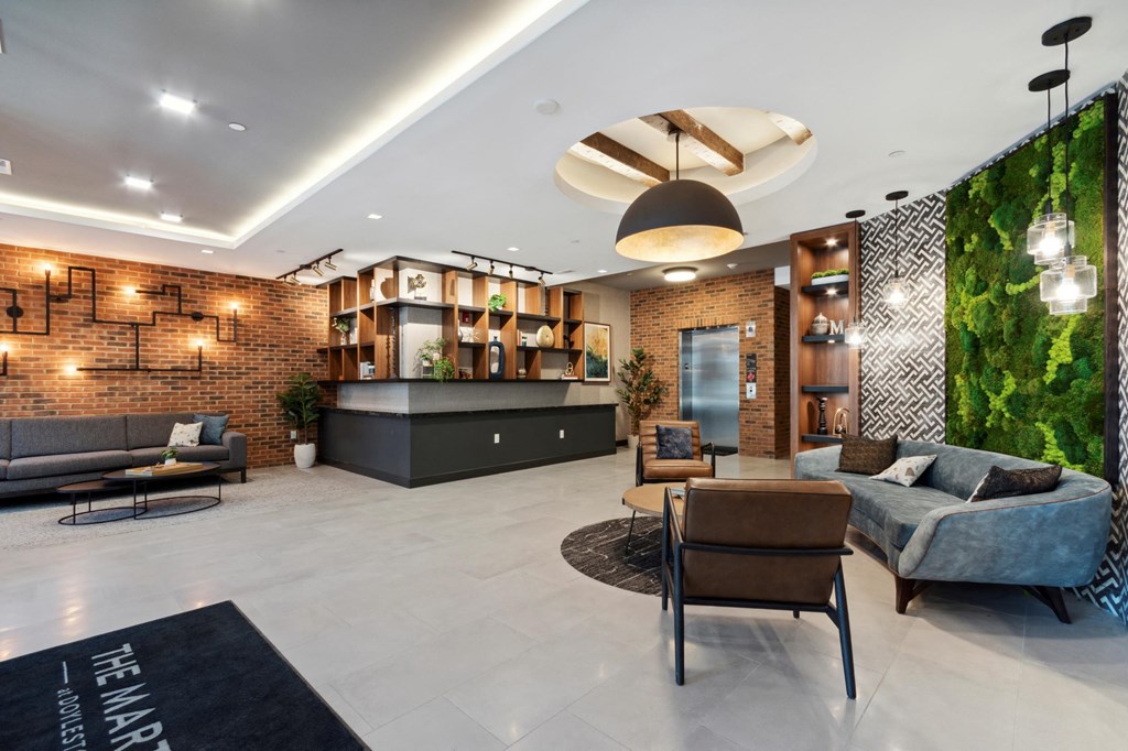 a lobby with couches and chairs and a green wall