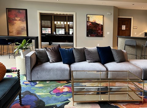 a living room with a couch and a glass coffee table