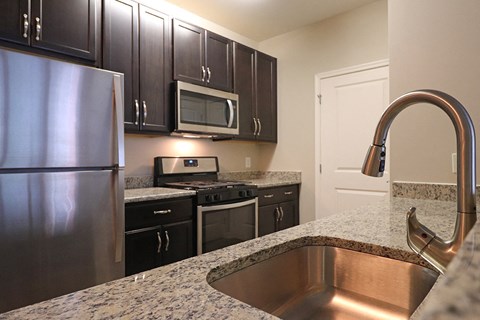 a kitchen with stainless steel appliances and granite counter tops