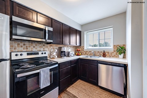 A kitchen with dark wood cabinets and stainless steel appliances.