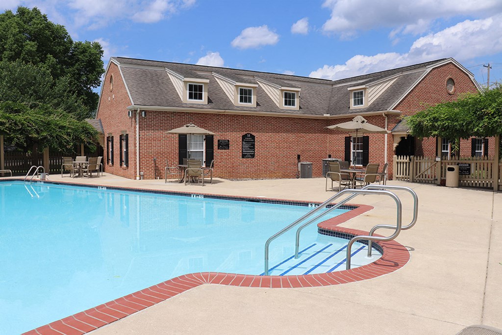 a swimming pool with a building in the background