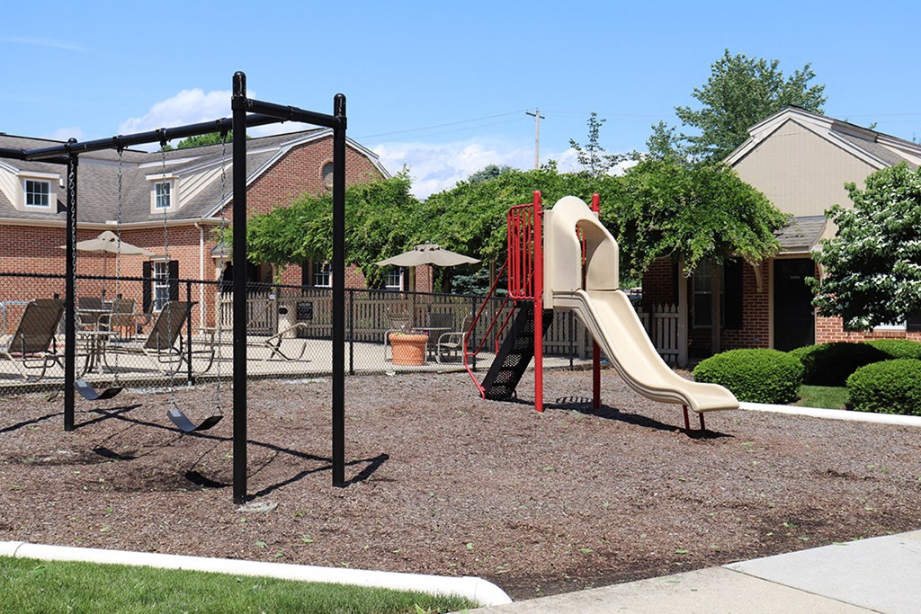a playground with a slide and a swing set