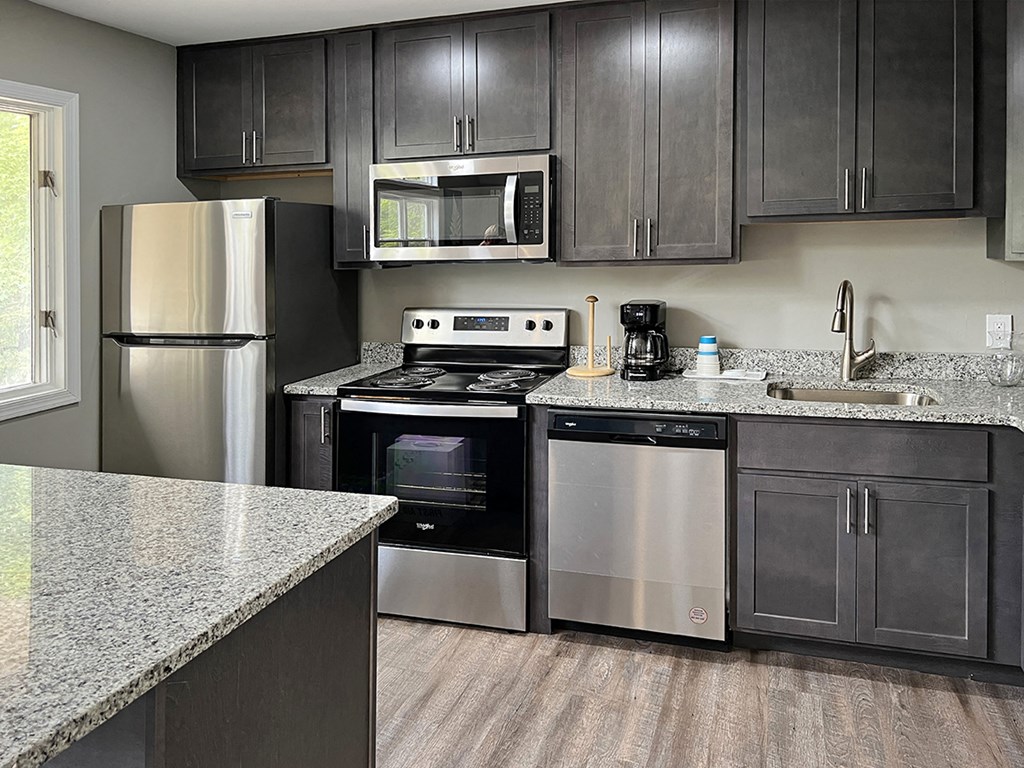 a kitchen with stainless steel appliances and granite countertops