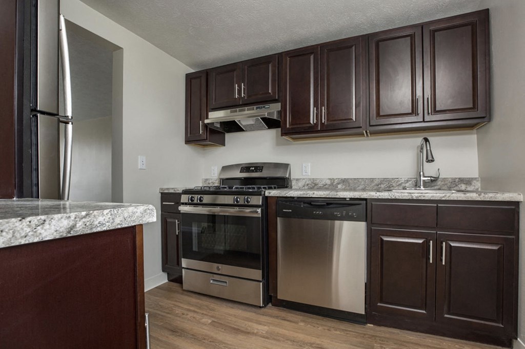 a kitchen with stainless steel appliances and marble counter tops