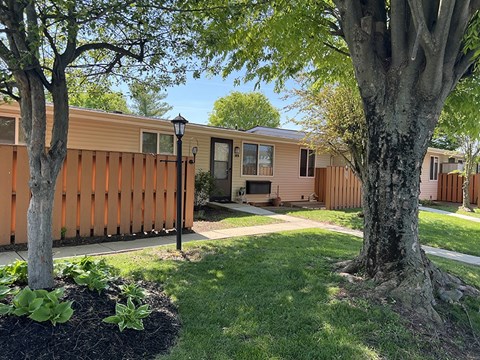 Shady trees and neat landscaping at Sunset Ridge Apartments.
