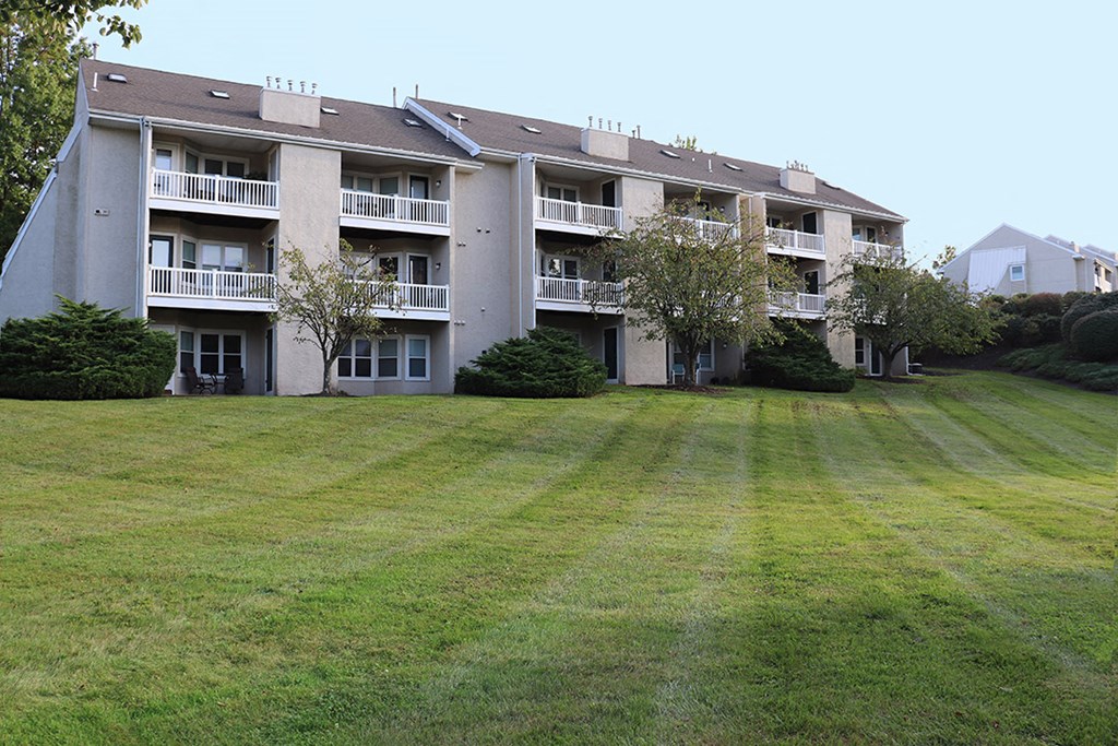 a large lawn in front of an apartment building