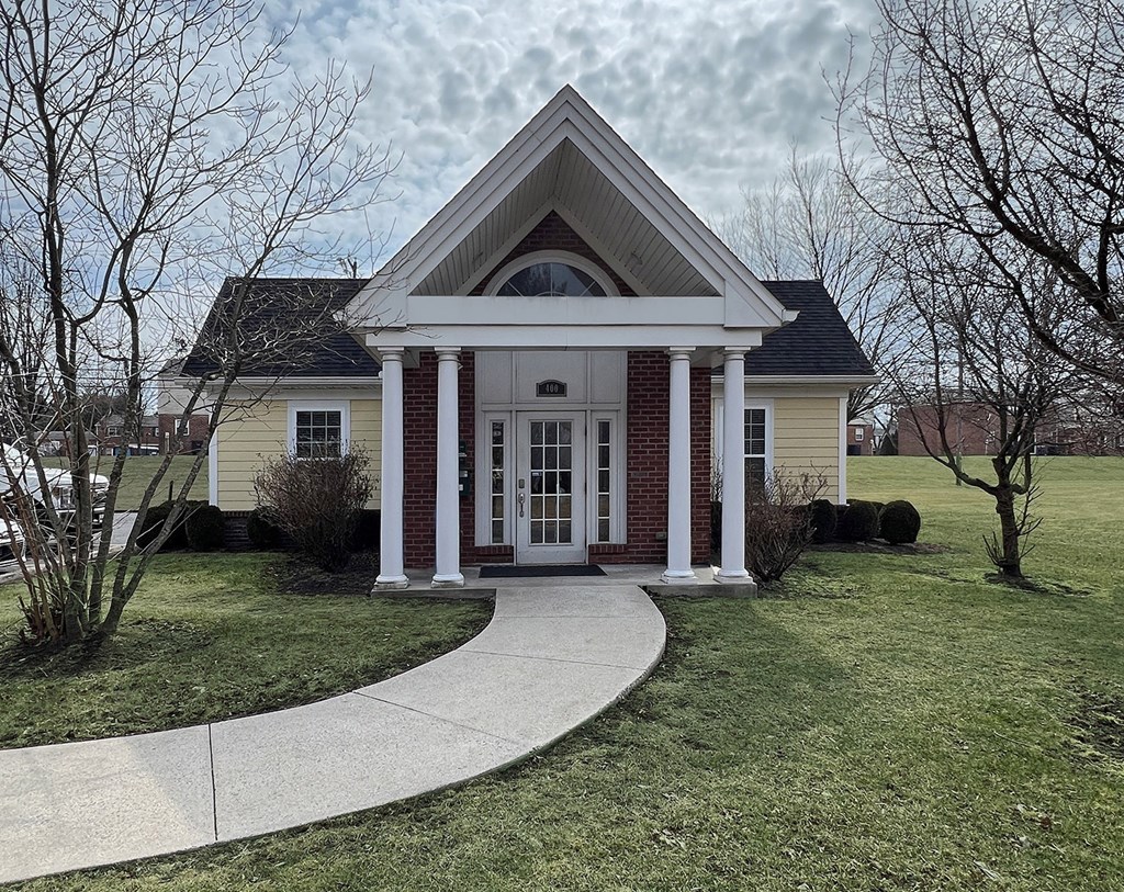 A house with a front porch and a walkway leading to the front door.