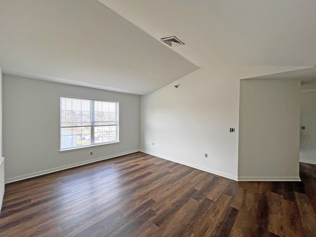 A room with wooden floors and a window.