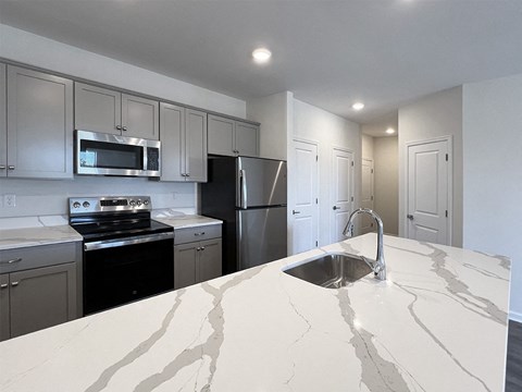 a kitchen with a marble counter top and a sink