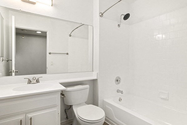 a white bathroom with a sink toilet and a tub