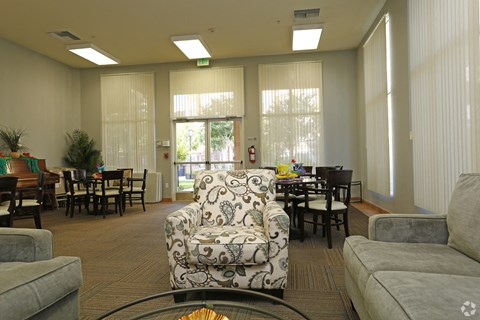 A living room with a patterned chair in the center.